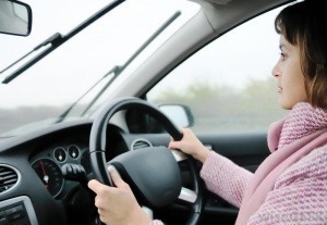woman-in-pink-coat-driving-a-car
